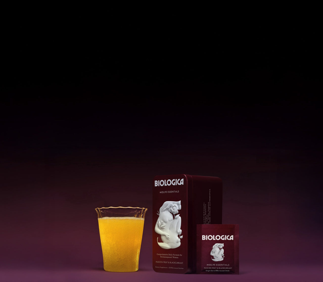 Two boxes of 'Biologica' on a dark background with a glass.